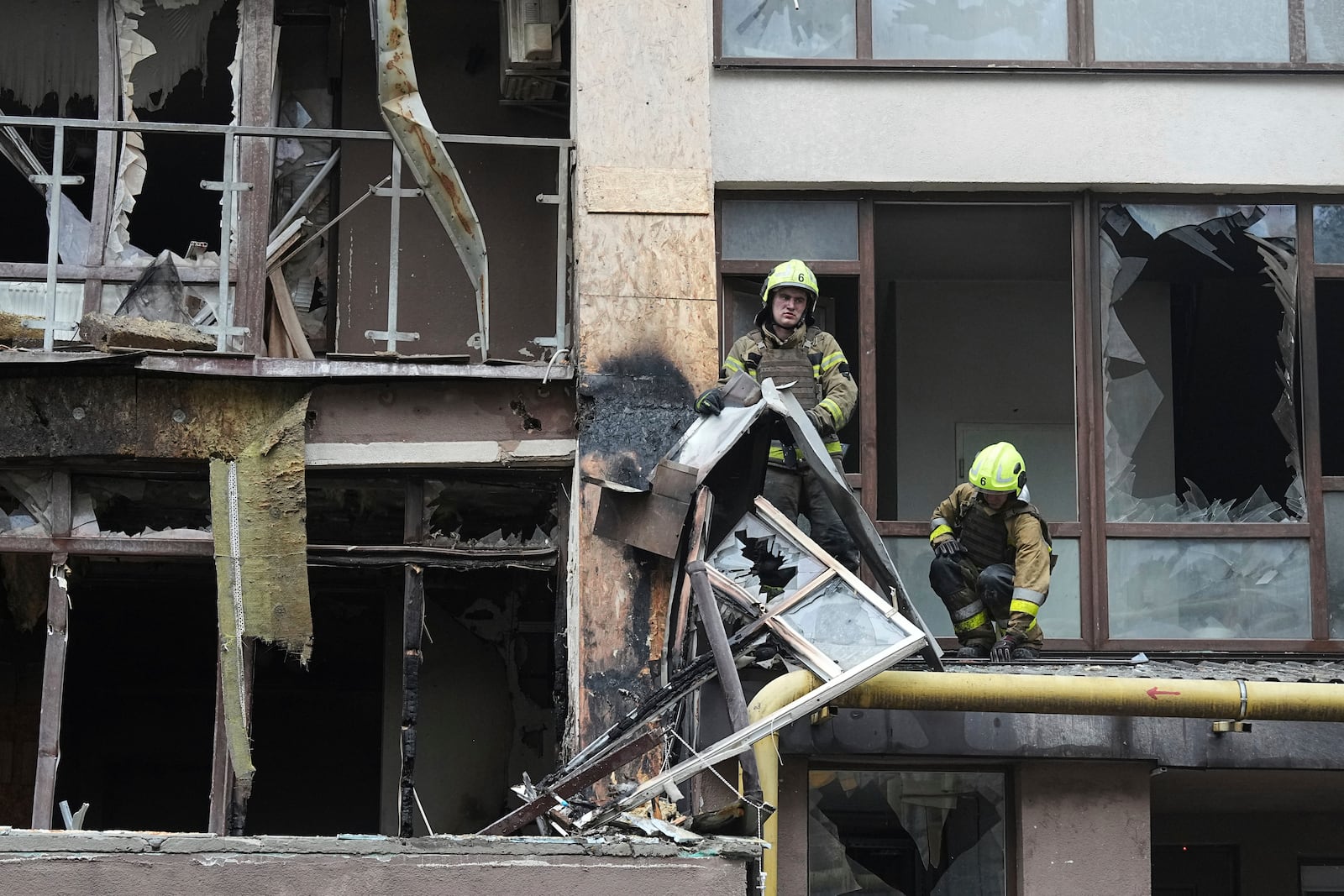 Firefighters work in a destroyed apartment building after a Russian attack in Kyiv, Ukraine, Monday, July 21, 2025. (AP Photo/Efrem Lukatsky)