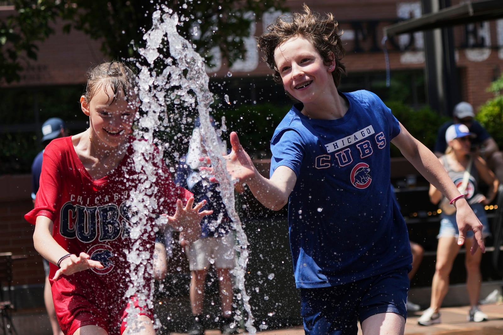 Kid cool off at a fountain during hot weather in Chicago, Sunday, June 22, 2025. (AP Photo/Nam Y. Huh)