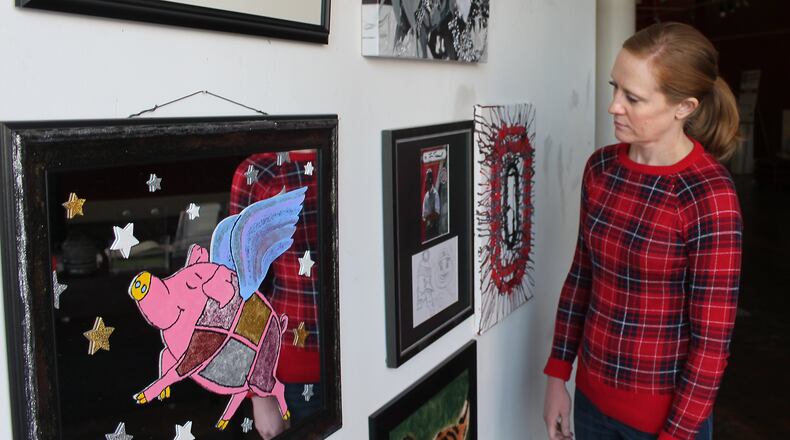 Heather Brackney Executive Director of the Champaign County Arts Council looks at some of the art work for this years Bad Art by Good People fundraiser. JEFF GUERINI/STAFF