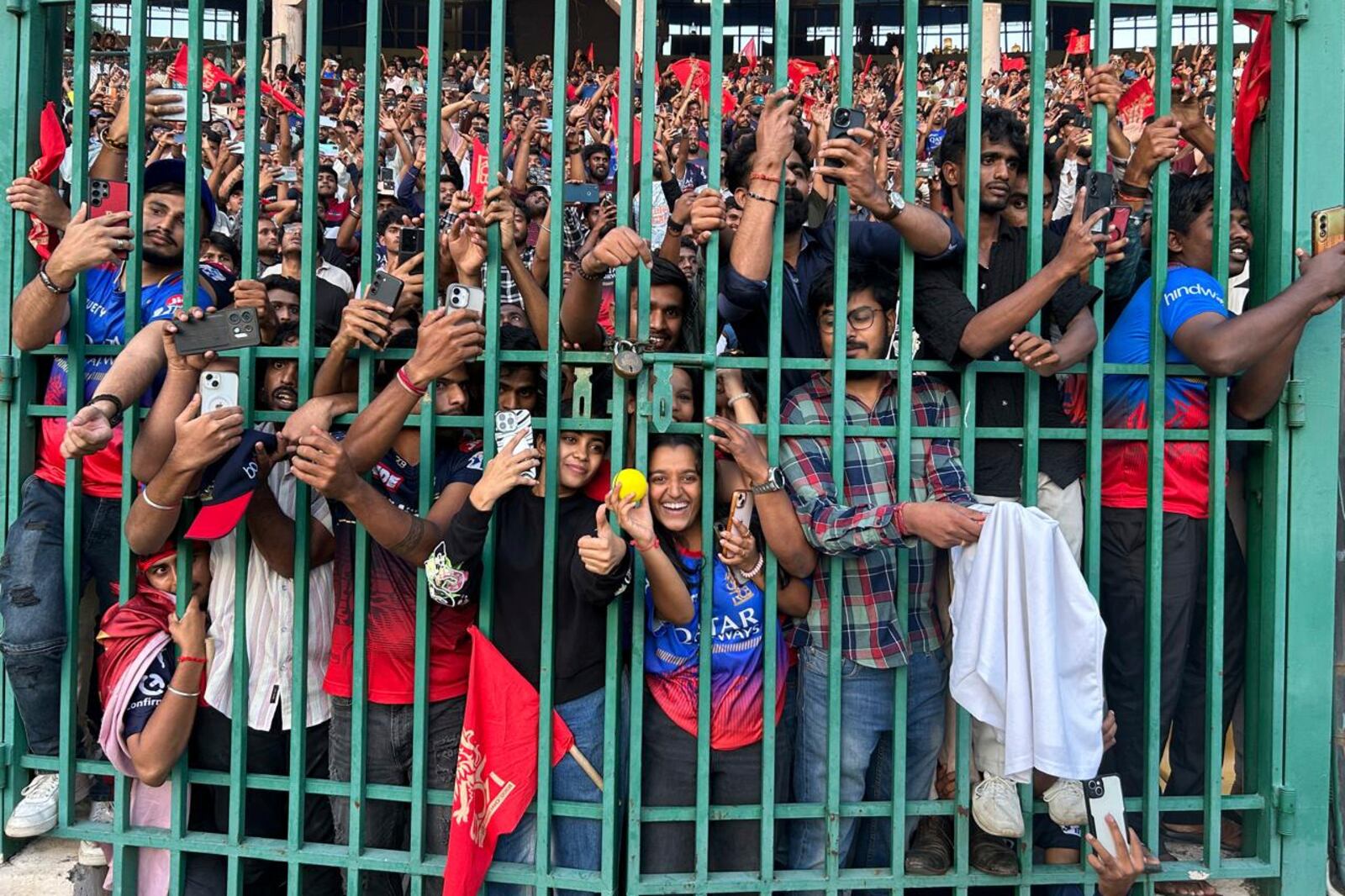 Fans gather to celebrate Royal Challengers Bengaluru cricketers, winners of the Indian Premier League, at the M. Chinnaswamy Stadium in Bengaluru, India, Wednesday, June 4, 2025. (AP Photo/Aijaz Rahi)