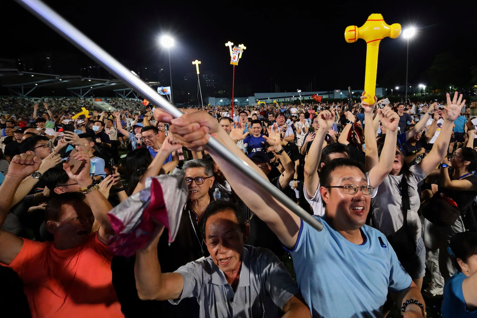 Workers' Party (WP) supporters react at an assembly centre during the general election, in Singapore, Saturday, May 3, 2025. (AP Photo/Suhaimi Abdullah)