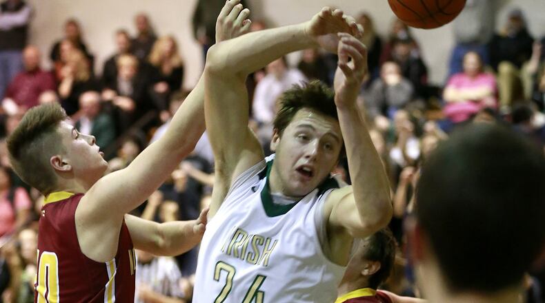 Catholic Central’s Cosmas Catanzaro and Northeastern’s Wesley Roberts battle for a rebound. BILL LACKEY / STAFF