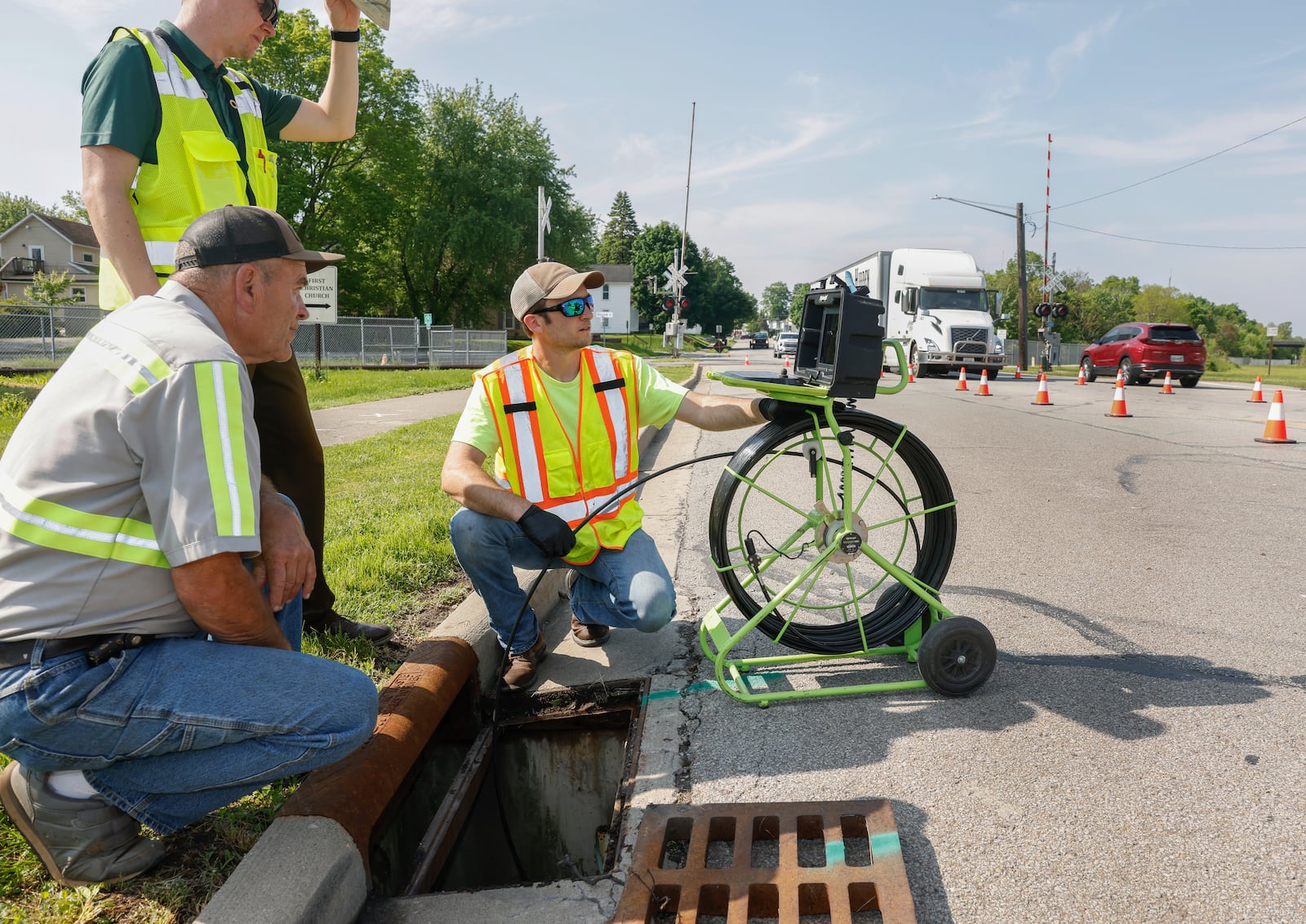 City of Urbana workers use a camera to analyze a sewer on North Main Street Thursday, May 15, 2025, in Urbana. JOSEPH COOKE/STAFF