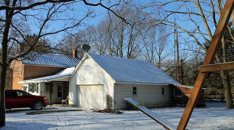 The Champaign county home is situated on 6 wooded acres. Exterior features include a 5-stall horse barn, a deck, a 3-acre pasture, a fenced yard, a gated, gravel driveway and a detached, 2-car workshop garage.