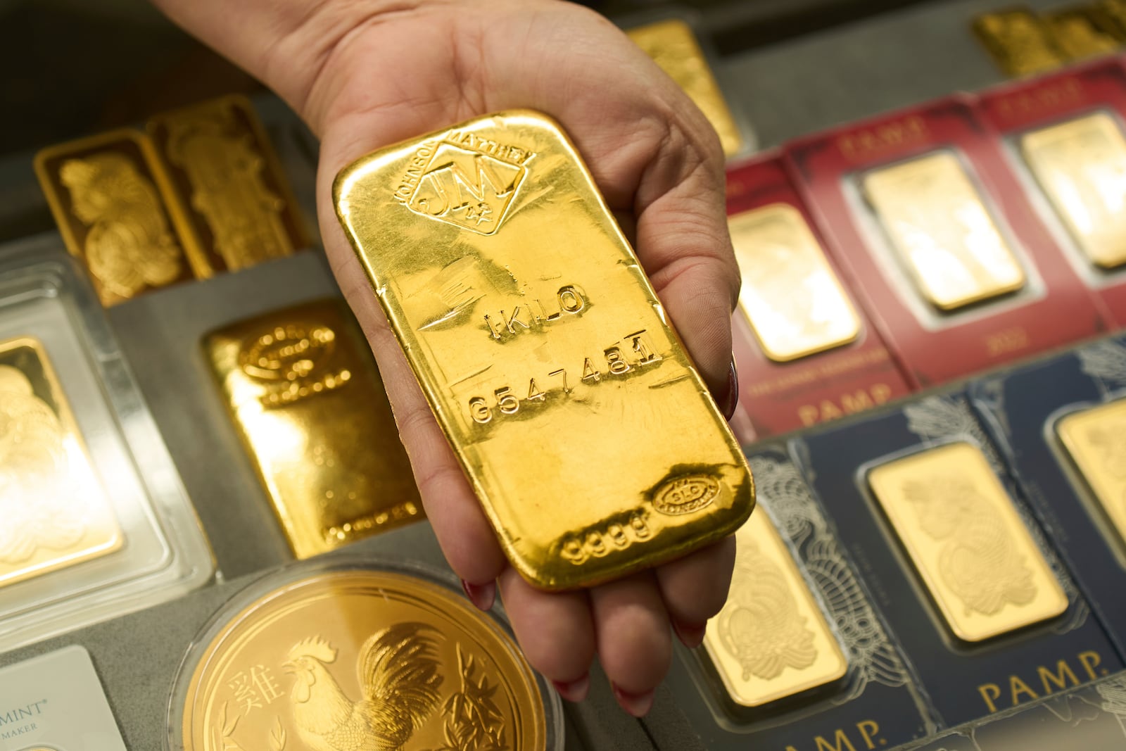 Sam Nguyen shows a gold bar at her shop in the St. Vincent Jewelry Center in the Jewelry District of Los Angeles, Wednesday, April 30, 2025. (AP Photo/Jae C. Hong)
