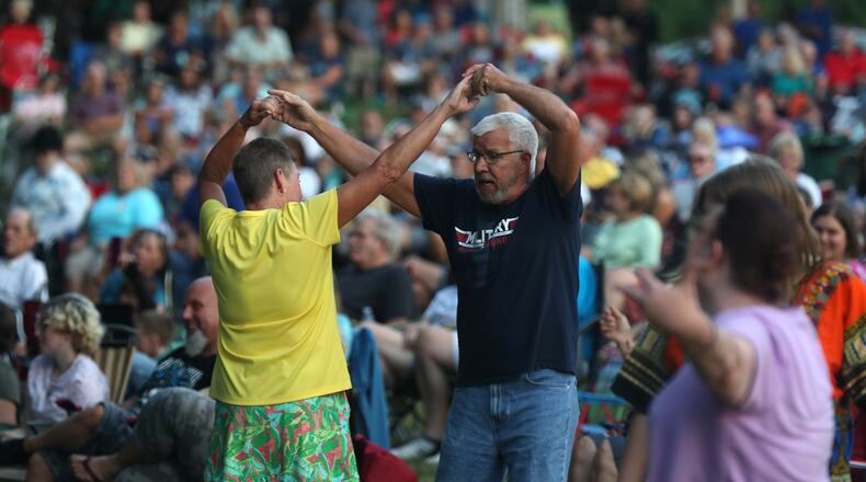 Bud and Yvonne Bell showed the crowd some dance moves Thursday night as they started dancing to the music of the K-Tel All-Stars during the opening night of the Summer Arts Festival at Veteran's Park. BILL LACKEY/STAFF