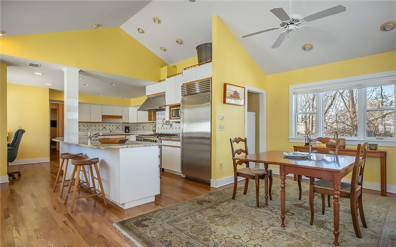The eat in kitchen has hardwood floors, recessed lighting and a ceiling fan over the breakfast area. There are stainless appliances including a sub zero refrigerator, range, three ovens, a beverage cooler and warming drawer There is also a pantry. CONTRIBUTED