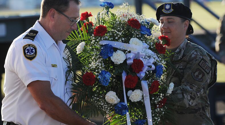 The Wright-Patterson community remembered lives lost Friday Sept. 9, 2022 in the terrorist attacks of 9/11 by participating in 5K run and 2K walk. Wright Patterson Fire Chief Jacob King, left and Lt. Col. Nichole Schatz placed a wreath for the fallen. MARSHALL GORBY\STAFF