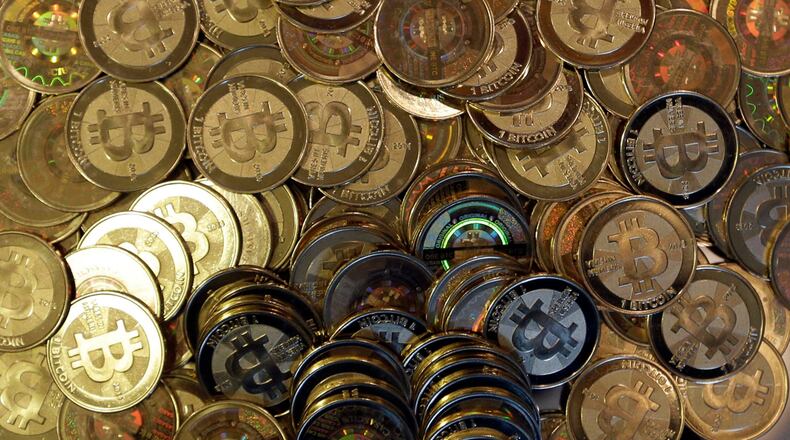 FILE - Bitcoin tokens are seen on April 3, 2013, in Sandy, Utah. (AP Photo/Rick Bowmer, File)