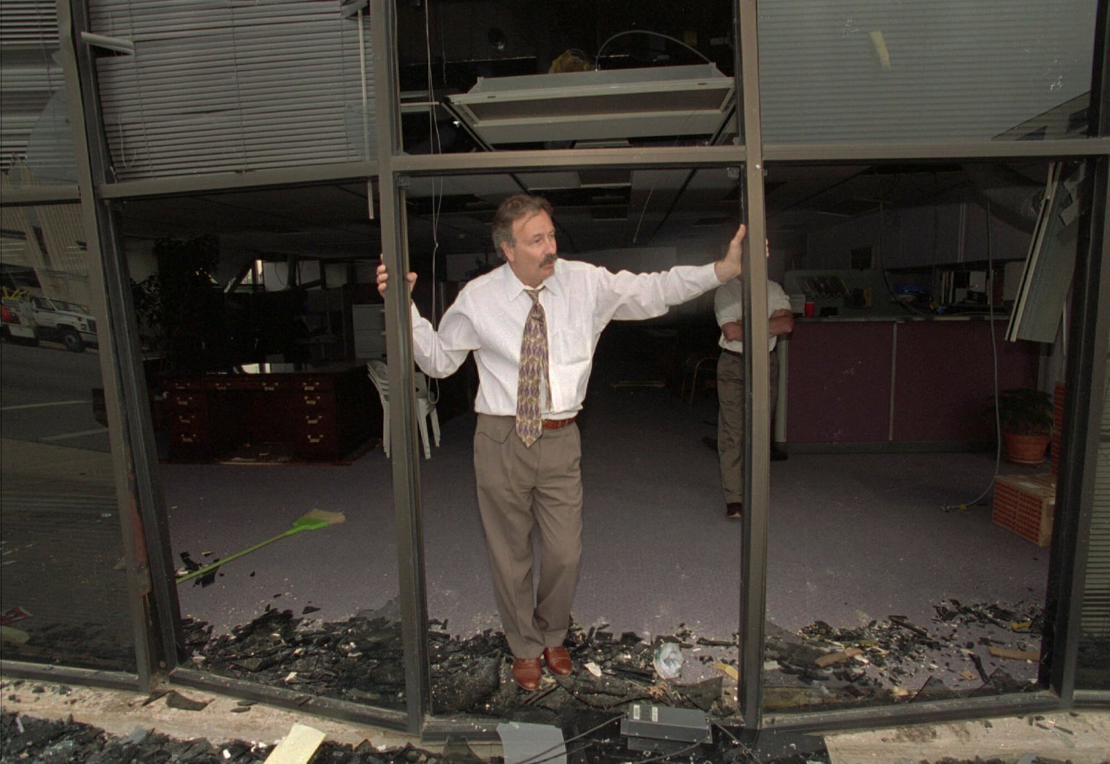 FILE - A man stands in the blown-out doorway of a downtown business a few blocks from the Alfred P. Murrah Federal Building, which was destroyed by a massive bomb, on April 19, 1995, in Oklahoma City. (AP Photo/Rick Bowmer, File)