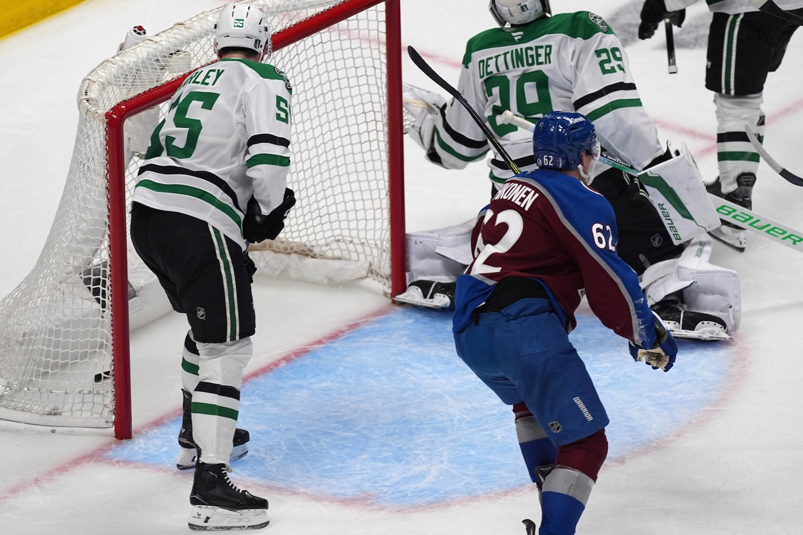 Colorado Avalanche left wing Artturi Lehkonen, front right, reacts after the puck went in the net past Dallas Stars goaltender Jake Oettinger, back right, as defenseman Thomas Harley looks on for the go-ahead goal awarded to Colorado's Nathan MacKinnon in the third period of Game 6 of an NHL first-round hockey playoff series Thursday, May 1, 2025, in Denver. (AP Photo/David Zalubowski)