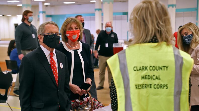 Governor Mike DeWine and his wife, Fran, talk with volunteers as they visit the Clark County vaccine distribution center. BILL LACKEY/STAFF