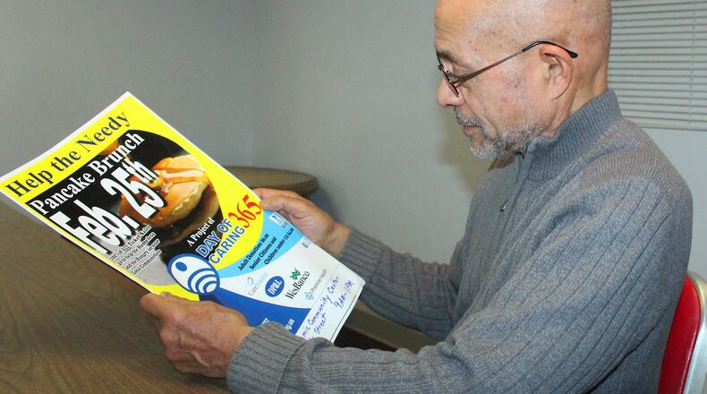 Mustafaa Islam with the An-Nur Islamic Community Center looks over a flyer for this years Pancake Brunch Day Of Caring. JEFF GUERINI/STAFF