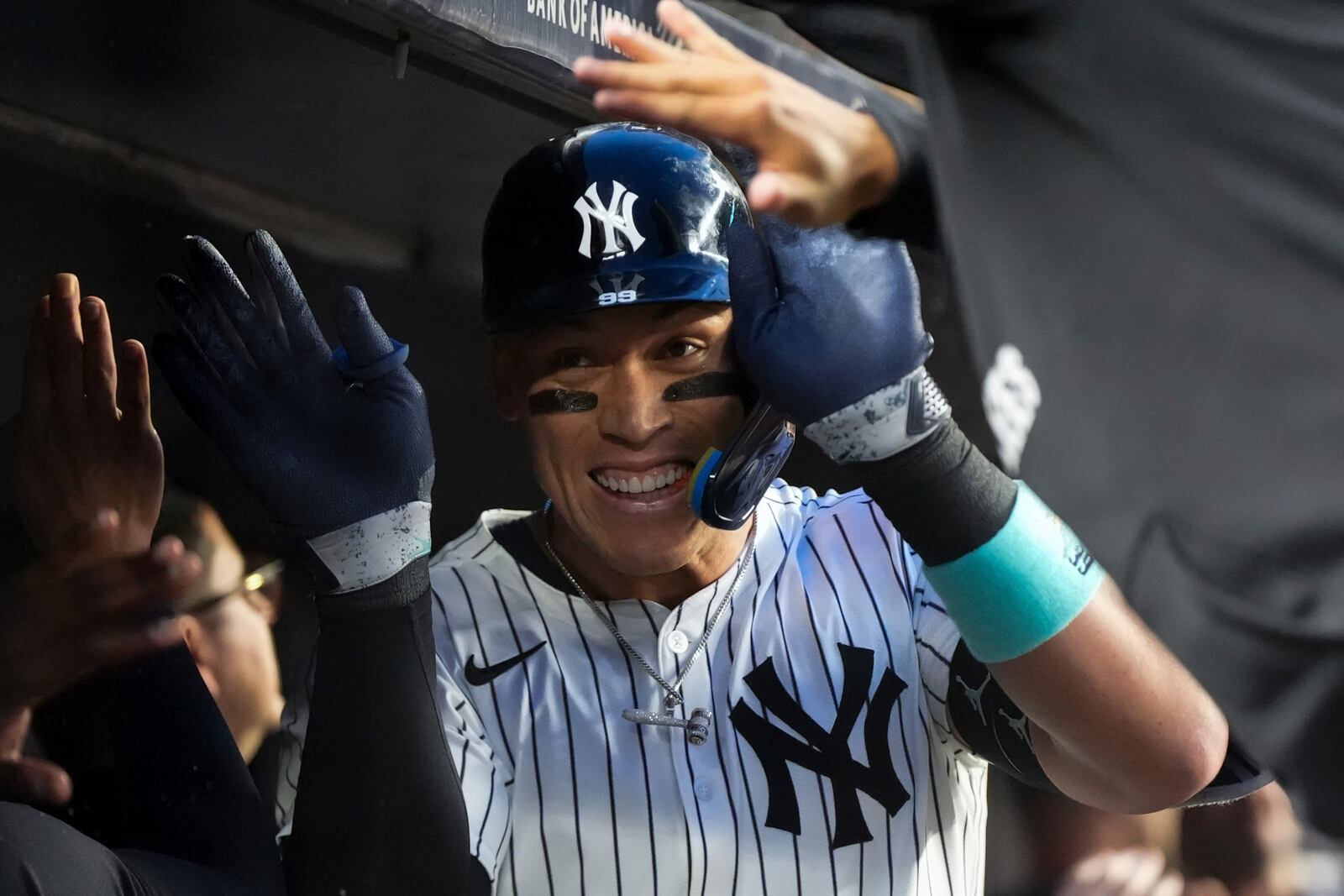 New York Yankees' Aaron Judge celebrates in the dugout after homering on a fly ball to right center field, his 500th extra base hit, during the first inning of a baseball game against the Arizona Diamondbacks, Thursday, April 3, 2025, in New York. (AP Photo/Julia Demaree Nikhinson)