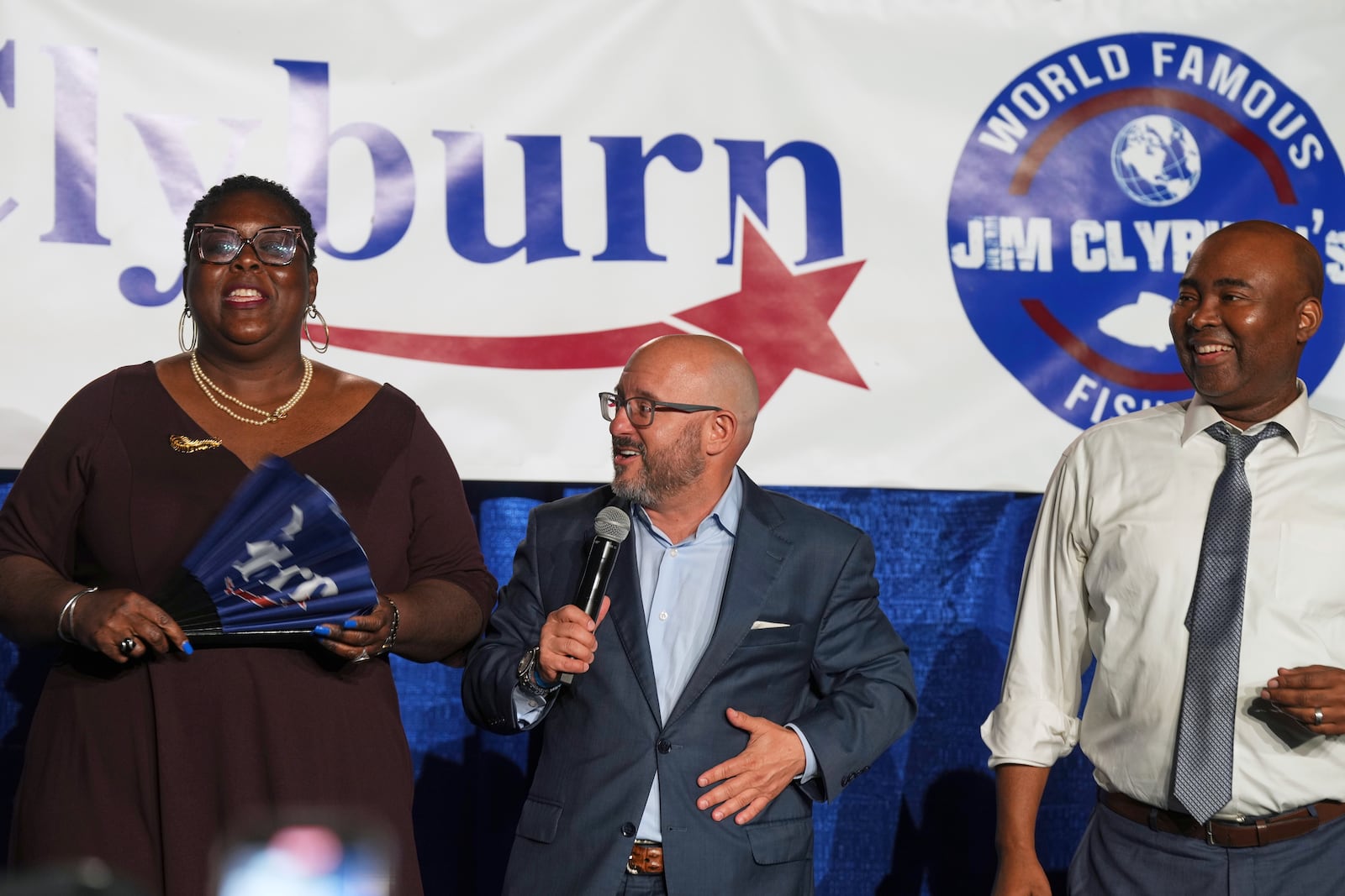South Carolina Democratic Party Chair Christale Spain, from left, and former chairs Trav Robertson and Jaime Harrison speak to attendees at Rep. Jim Clyburn's World Famous Fish Fry, Friday, May 30, 2025, in Columbia, S.C. (AP Photo/Meg Kinnard)