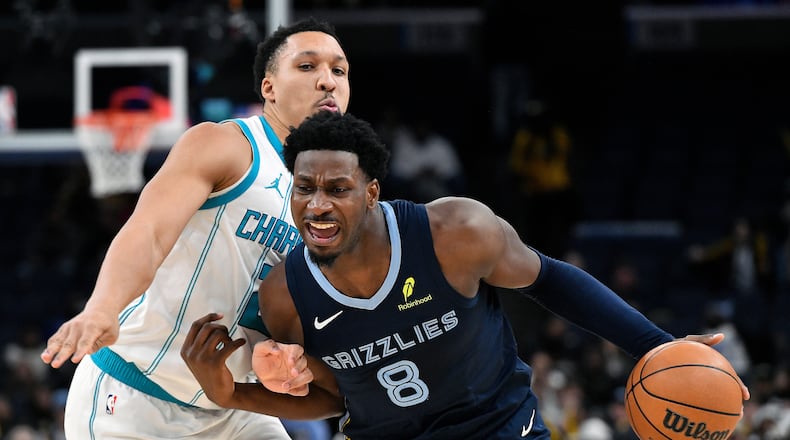 Memphis Grizzlies forward Jaren Jackson Jr. (8) handles the ball against Charlotte Hornets forward Grant Williams (2) in the second half of an NBA basketball game Wednesday, Jan. 28, 2026, in Memphis, Tenn. (AP Photo/Brandon Dill)