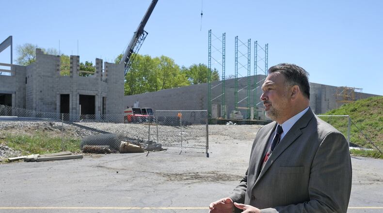 Urbana Schools superintendent Charles Thiel talks about the progress of the Urbana schools construction Monday in front of the new Urbana High School. Bill Lackey/Staff