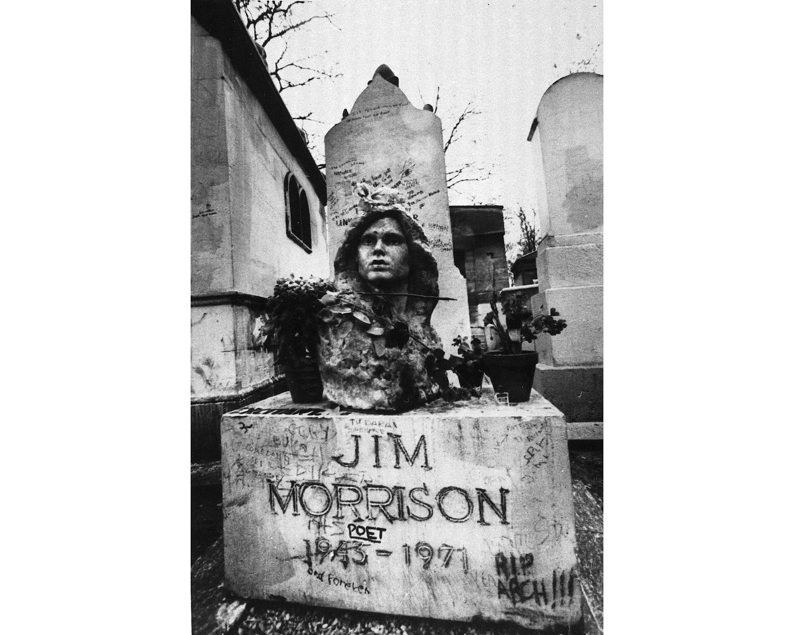 FILE- This Sept. 7, 1971 file photo shows the grave of Jim Morrison, lead singer of the rock group "The Doors," at the Pere Lachaise cemetery in Paris, France. (AP Photo/Joe Marquette,File)