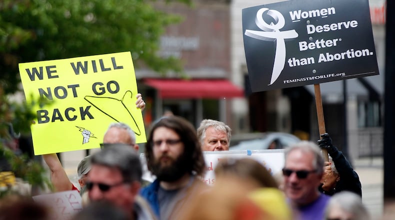 A pro-choice rally drew about 100 people to North Main Street in Dayton in 2019. Ohio abortion clinics and advocacy groups hailed a decision Feb. 2 to pause enforcement of a new abortion law.  TY GREENLEES / STAFF