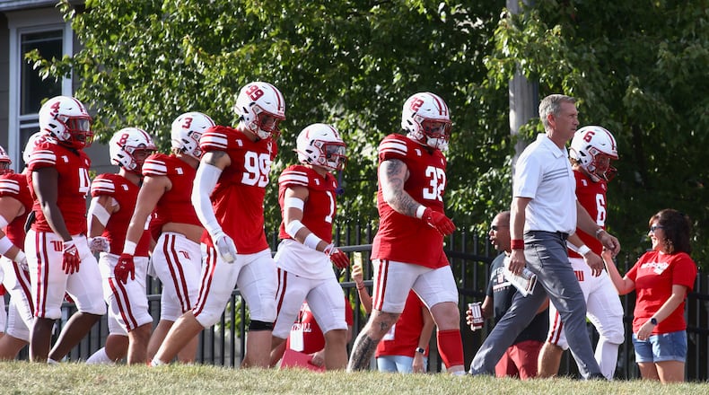 Wittenberg's Jim Collins leads the team onto the field before a game against Kenyon on Saturday, Sept. 16, 2023, at Edwards-Maurer Field in Springfield. David Jablonski/Staff