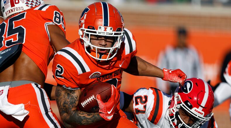 National running back Chase Brown (2), of Illinois, carries the ball during the second half of the Senior Bowl NCAA college football game Saturday, Feb. 4, 2023, in Mobile, Ala.. (AP Photo/Butch Dill)
