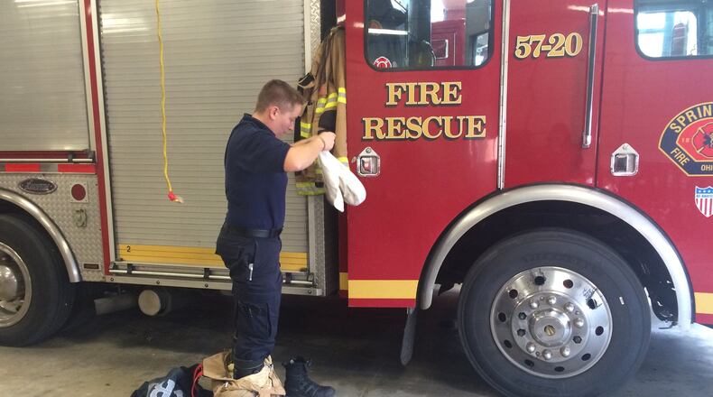 A Springfield Fire/Rescue Division firefighter prepares for a run at Station No. 1. The fire division faces $60,000 in overtime cuts next year as the city looks to address a deficit. Katherine Collins/Staff