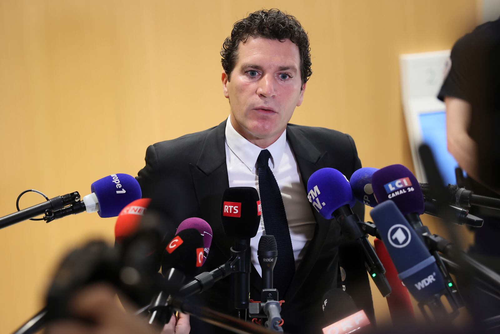 French actor Gerard Depardieu's lawyer Jeremie Assous speaks with the media after a verdict was delivered on accusations that the actor sexually assaulted two women who were working on a film with him in 2021, in Paris, Tuesday, May 13, 2025. (AP Photo/Thomas Padilla)