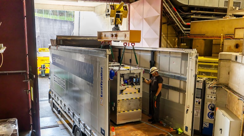 Technicians load the transportable antimatter trap into a truck from the Antimatter Factory at the European Organization for Nuclear Research (CERN) for a road test in Meyrin near Geneva, Switzerland, Tuesday, March 24, 2026. (Salvatore Di Nolfi/Keystone via AP)