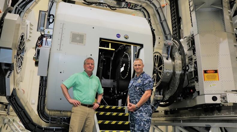 Naval Medical Research Unit Dayton (NAMRU-Dayton) research psychologist Henry Williams (left), and Capt. Richard Folga (right), Naval aerospace and operational physiologist near the Disorientation Research Device (DRD). The DRD, sometimes called the "Kraken," is a one-of-a kind Navy aerospace medicine research device. Navy photo