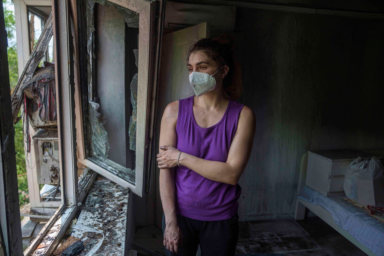 Karyna Holf, 25, stands in her apartment which was damaged by a Russian drone strike in Kyiv, Ukraine, on Thursday, July 10, 2025. (AP Photo/Evgeniy Maloletka)