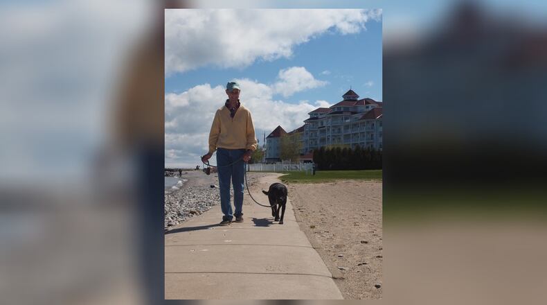 Teddy, the trainer, taking his client, Ed, for a walk. JORDAN BLAKE/CONTRIBUTED