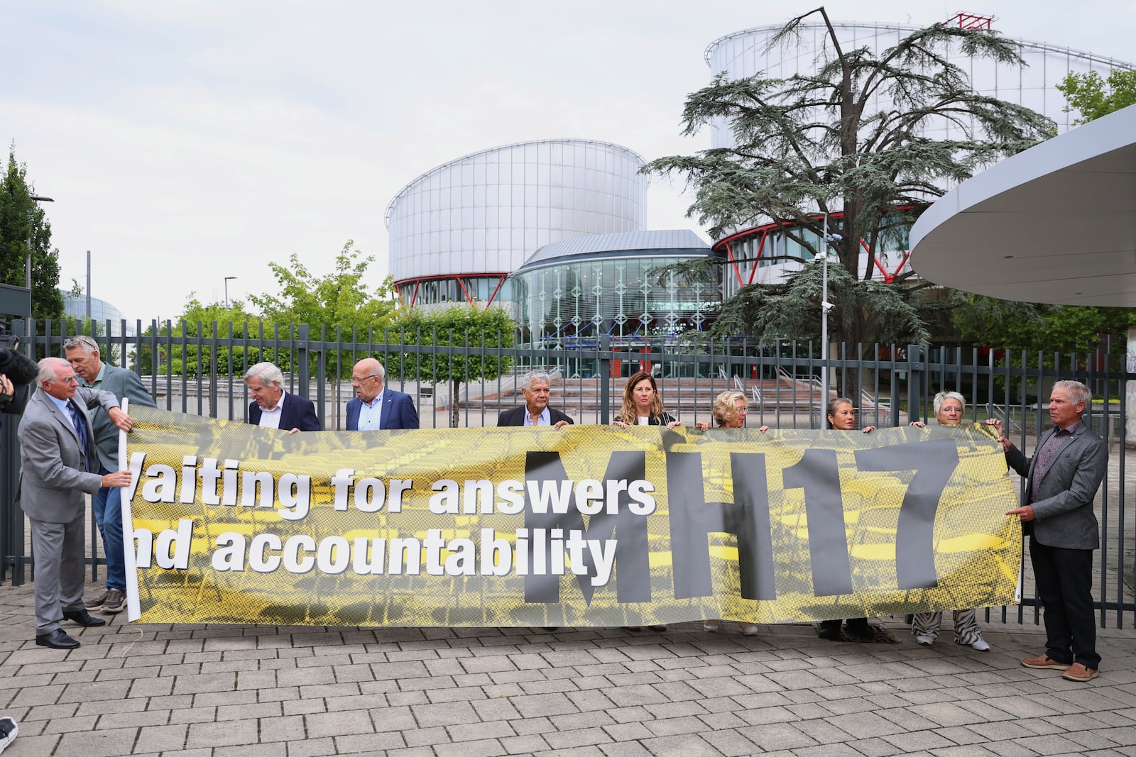 People demonstrate outside the European Court of Human Rights before it issues a landmark set of rulings about alleged Russian violations in Ukraine since 2014, including the downing of Malaysia Airlines flight MH17, Wednesday, July 9, 2025 in Strasbourg, eastern France. (AP Photo/Antonin Utz)