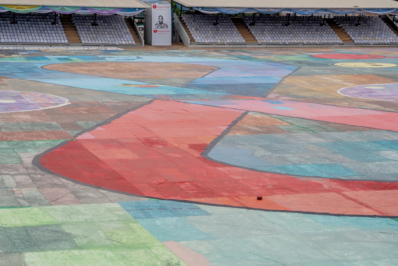 An Ariel view of the canvas painting by Kanyeyachukwu Tagbo-Okeke, a 15-year-old autistic artist who won the Guinness World Record for the largest art canvas, on display at the Eagle Square on World Autism Day in Abuja, Nigeria, Wednesday, April 2, 2025. (AP Photo/David Durowaiye)