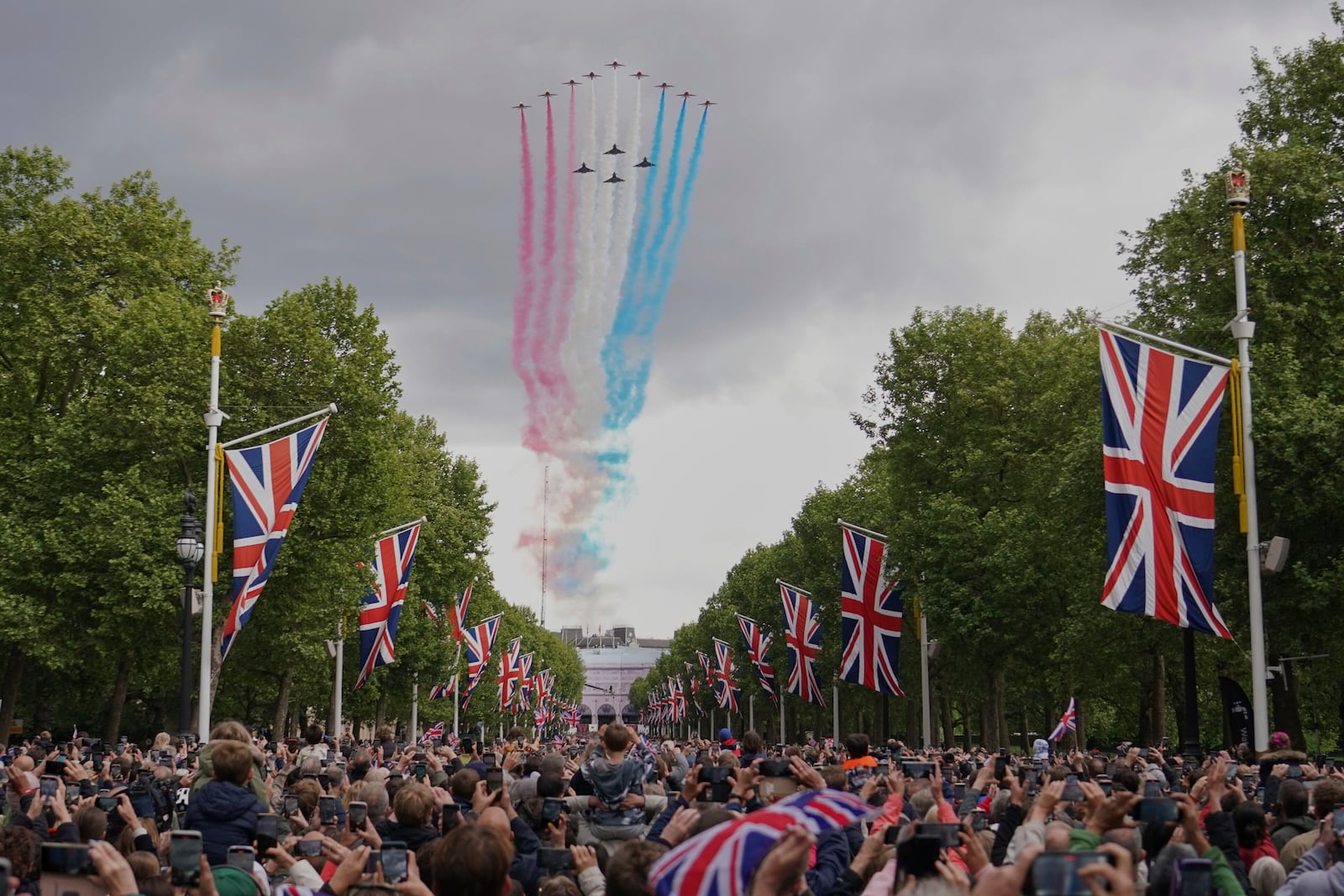 The Red Arrows the Royal Airforce display team, fly over the Mall and Buckingham Palace during the V-E Day 80th anniversary parade in London, Monday, May 5, 2025. (AP Photo/Alberto Pezzali, Pool)