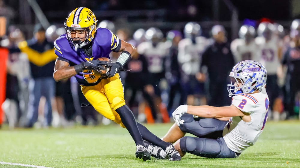 Springfield High School senior Sherrod Lay, Jr. breaks free from Marysville's JJ Henry during their game on Friday, Oct. 31 at Wildcat Stadium. Springfield won 35-6. MICHAEL COOPER / STAFF PHOTO