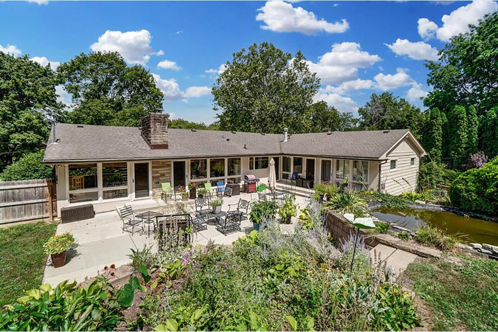 The rear of the home has two patios – one walk out from the finished basement to a paver patio. A second patio is concrete and has several doors leading to the inside of the house. The back also featured brick and stone terraced walls and steps and a fish pond with aquatic plants. CONTRIBUTED PHOTO