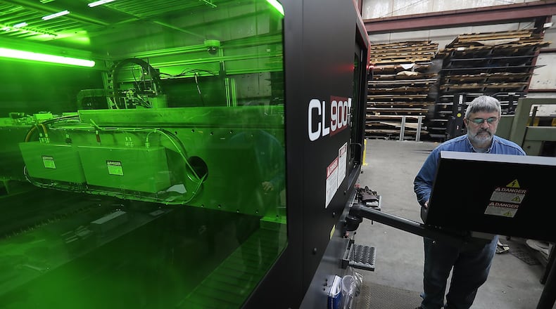 Jeff Spradlin operates a lazer cutter at Spradlin Bros. Welding Thursday. Spradlin Bros. Welding received about $400,000 in loans from the state. The company says the loan will allow it to add three employees and retain 15 others. BILL LACKEY/STAFF