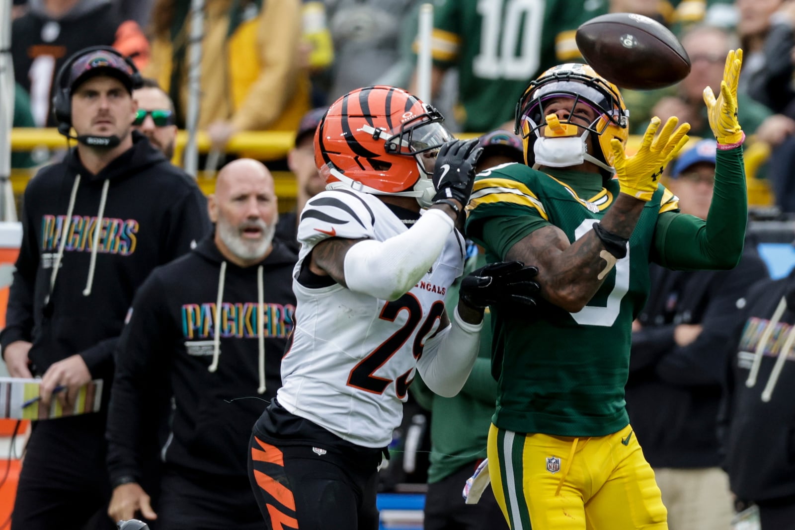 Green Bay Packers' Matthew Golden (0) makes a catch against Cincinnati Bengals cornerback Cam Taylor-Britt (29) in the first half of an NFL football game, Sunday, Oct. 12, 2025, in Green Bay, Wis. (AP Photo/Matt Ludtke)