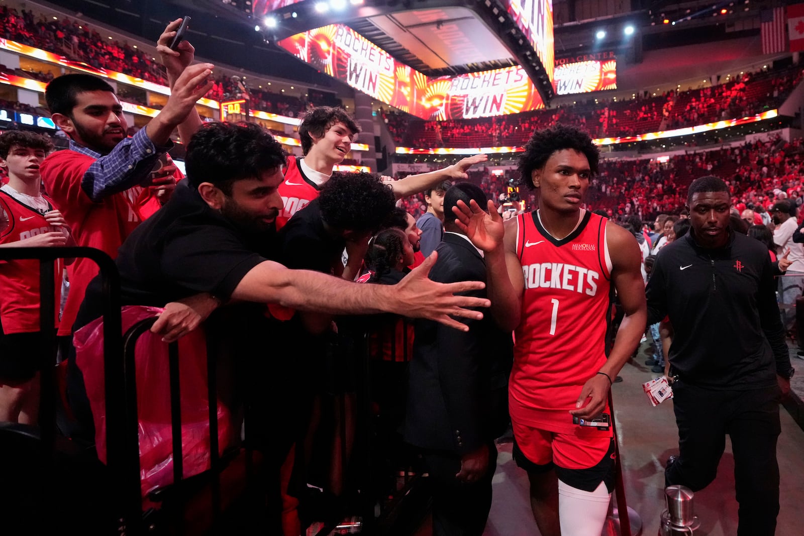 Houston Rockets forward Amen Thompson high fives fans after Game 5 of an NBA basketball first-round playoff series against the Golden State Warriors, Wednesday, April 30, 2025, in Houston. (AP Photo/David J. Phillip)