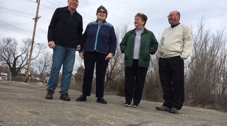 Dayton-area Delphi salaried retirees (from left), Tom Rose, Mary Miller, Marlane Bengry and Tom Green, standing on the foundation of the former Delphi Wisconsin Boulevard plant in Dayton in March 2018. THOMAS GNAU/STAFF