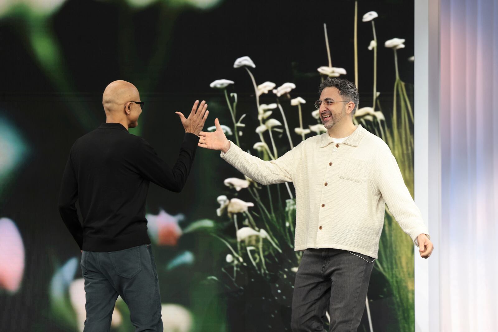 Microsoft AI CEO Mustafa Suleyman, right, is welcomed on stage by Chairman and CEO Satya Nadella during a presentation of the company's AI assistant, Copilot, ahead of a 50th Anniversary presentation at Microsoft headquarters, Thursday, March 14, 2024, in Redmond, Wash. (AP Photo/Jason Redmond)