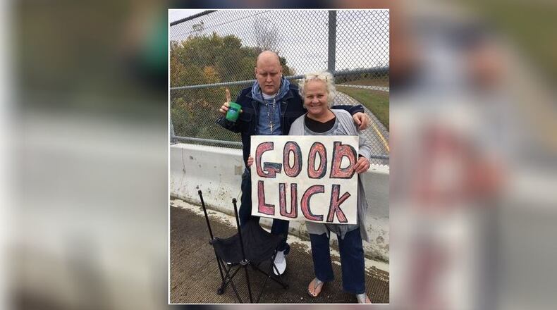 Nick Henry and his mom Lori Baker cheer for the riders in the 42nd Annual Highway Hikers Motorcycle Club Christmas Toy Run to benefit the Springfield Salvation Army Chistmas project. Henry and Baker watched as motorcyclists passed under the Old Mill overpass. Pam Cottrel/Contributor