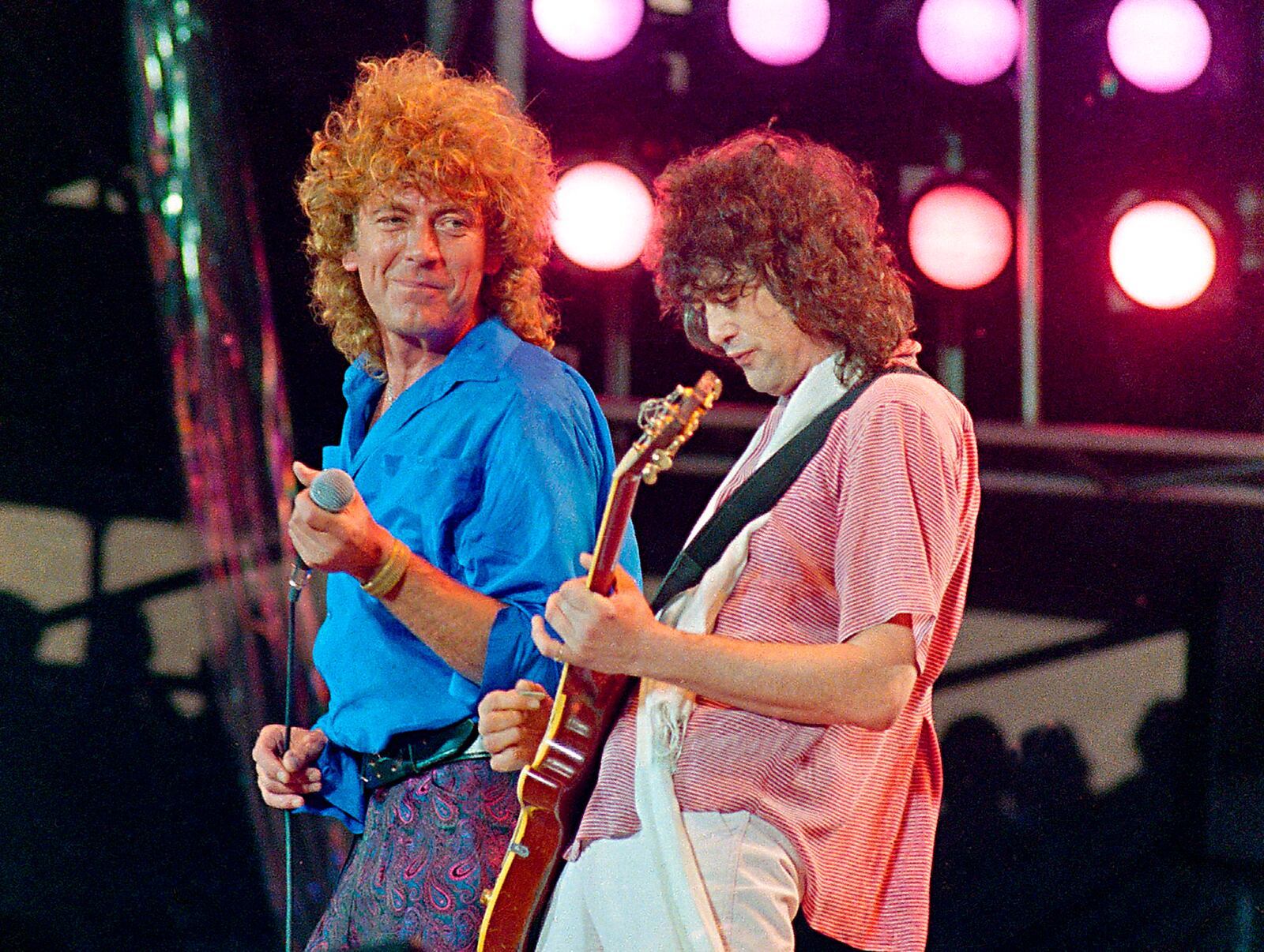 FILE - Led Zeppelin bandmates, singer Robert Plant, left, and guitarist Jimmy Page, perform for the Live Aid famine relief concert at JFK Stadium in Philadelphia on July 13, 1985. (AP Photo/Amy Sancetta, File)