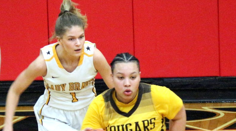 Kenton Ridge senior Desiree Jones (4) combined with junior teammate Kirsten Wiley to score the Cougars’ final five points in a 42-40 Division II sectional defeat of Shawnee on Thursday. GREG BILLING / CONTRIBUTED