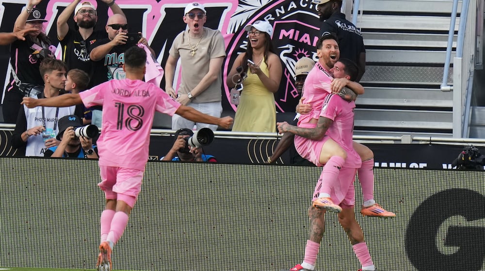 Inter Miami midfielder Rodrigo de Paul (7) celebrates a goal with forward Lionel Messi (10) and defender Jordi Alba (18) during the second half of the MLS Cup final soccer match against the Vancouver Whitecaps Saturday, Dec. 6, 2025, in Fort Lauderdale, Fla. (AP Photo/Lynne Sladky)