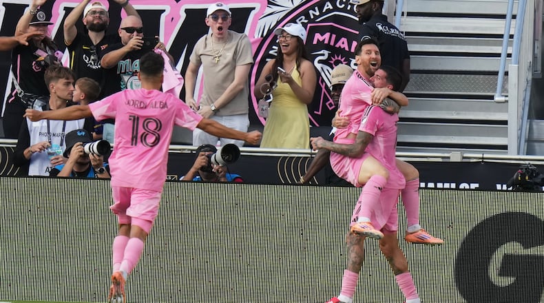 Inter Miami midfielder Rodrigo de Paul (7) celebrates a goal with forward Lionel Messi (10) and defender Jordi Alba (18) during the second half of the MLS Cup final soccer match against the Vancouver Whitecaps Saturday, Dec. 6, 2025, in Fort Lauderdale, Fla. (AP Photo/Lynne Sladky)