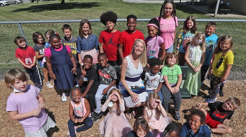 Rebecca Reid, admistrator at Risen Christ Lutheran School, with some of the students who attend the school Friday. BILL LACKEY/STAFF