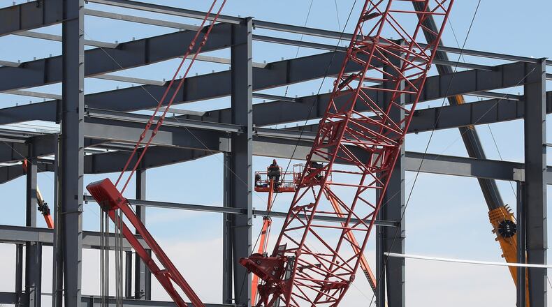 Workers place the steel beams in place on the Topre America construction site Monday. Topre announced plans to invest $73M and add 204 new jobs to Springfield. That is on top of an announcement last year the company planned to invest $55 million and create 55 jobs. Bill Lackey/Staff