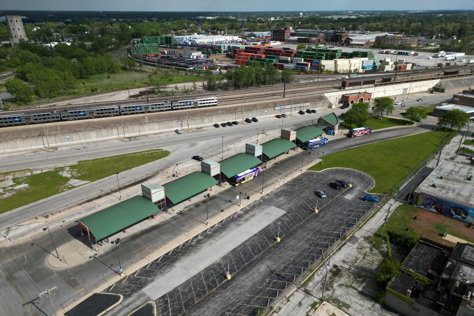 A Metra train, top, is seen in the tracks across from the Pace Harvey Transportation Center, Thursday, May 29, 2025, in Harvey, Ill. (AP Photo/Erin Hooley)