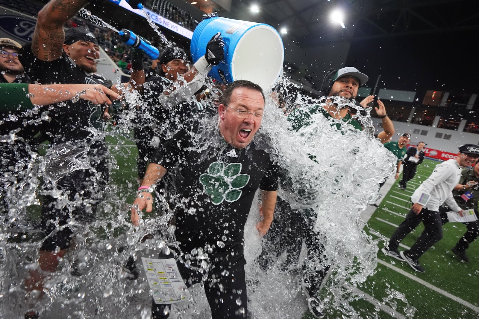 Ohio interim head coach John Hauser is doused after winning the Frisco Bowl NCAA college football game against UNLV, Tuesday, Dec. 23, 2025, in Frisco, Texas. (AP Photo/LM Otero)